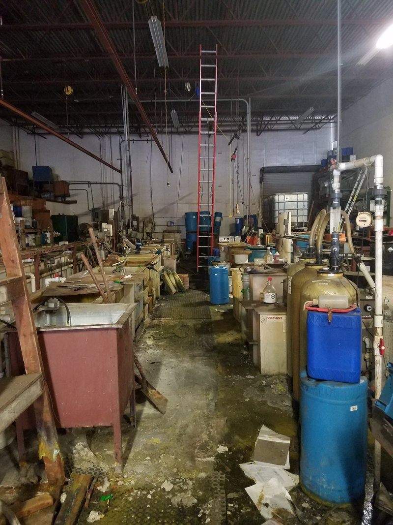 Plating process area with tanks and scattered containers