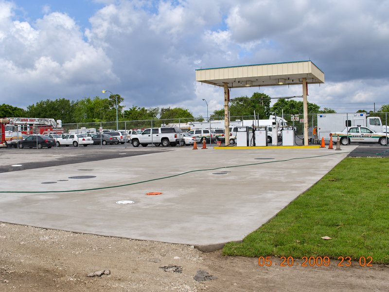 Finished concrete pad in front of the fuel canopy