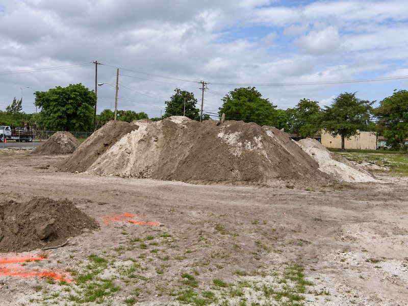 Stockpiles of excavated soil on a cleared lot