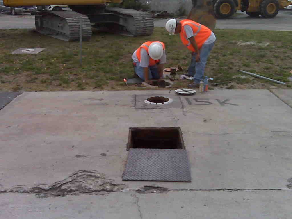 Technicians sampling a groundwater monitoring well