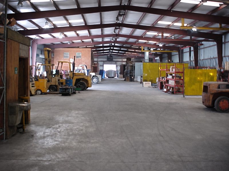 Interior of a large warehouse with forklifts and racking