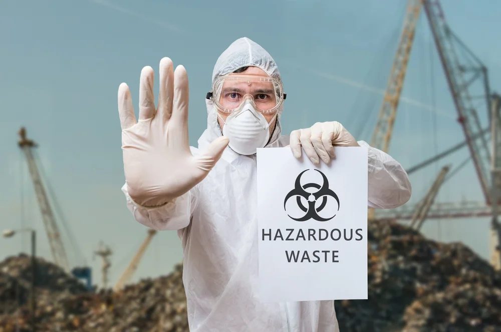 Technician handling hazardous waste