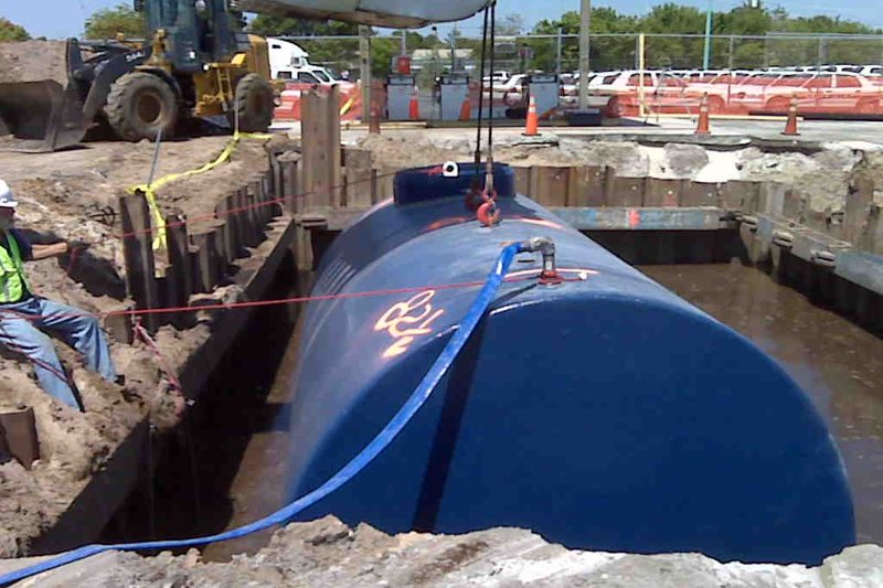 New underground fuel tank being set into an excavation